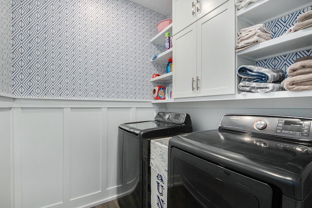 172 Bay Meadows Dr, Holland, MI 49424 - laundry room featuring washing machine and dryer, cabinet space, and a decorative wall