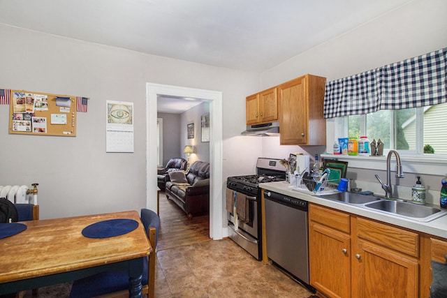 1019/1021 N Michigan Ave, Howell, MI 48843 - kitchen with appliances with stainless steel finishes, under cabinet range hood, and light countertops