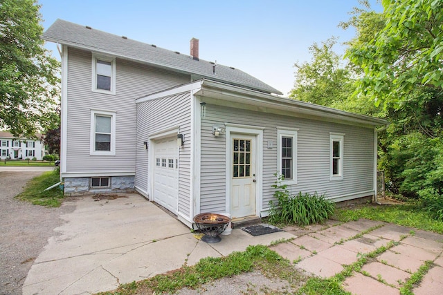 1019/1021 N Michigan Ave, Howell, MI 48843 - rear view of house featuring a chimney