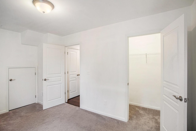 2817 Hartwick Dr, Rochester Hills, MI 48307 - unfurnished bedroom featuring carpet and a walk in closet