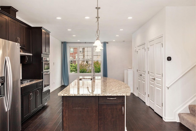 2817 Hartwick Dr, Rochester Hills, MI 48307 - kitchen featuring stainless steel appliances, an island with sink, dark wood-type flooring, recessed lighting, and light stone counters