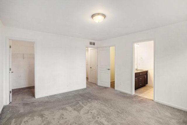 2817 Hartwick Dr, Rochester Hills, MI 48307 - unfurnished bedroom featuring light colored carpet, a walk in closet, and ensuite bath