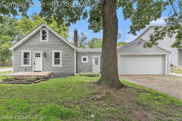 21801 Colgate St, Farmington Hills, MI 48336 - view of front facade with driveway, a chimney, a garage, and a front lawn