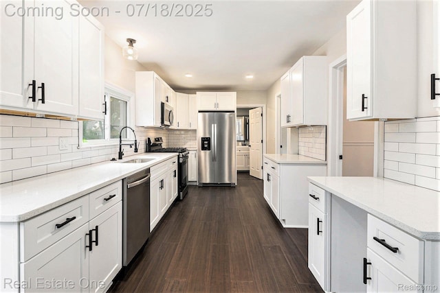 21801 Colgate St, Farmington Hills, MI 48336 - kitchen with appliances with stainless steel finishes, tasteful backsplash, dark wood-style flooring, white cabinets, and recessed lighting
