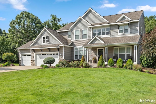 5362 Settlers Grove Rd NE, Belmont, MI 49306 - craftsman-style house featuring a porch, a front yard, concrete driveway, and stone siding