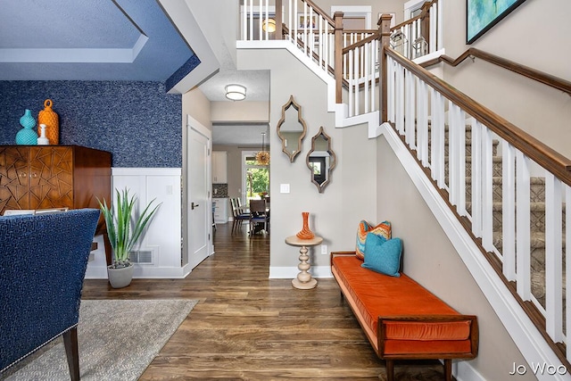 5362 Settlers Grove Rd NE, Belmont, MI 49306 - entryway with wood finished floors, stairway, wallpapered walls, and wainscoting