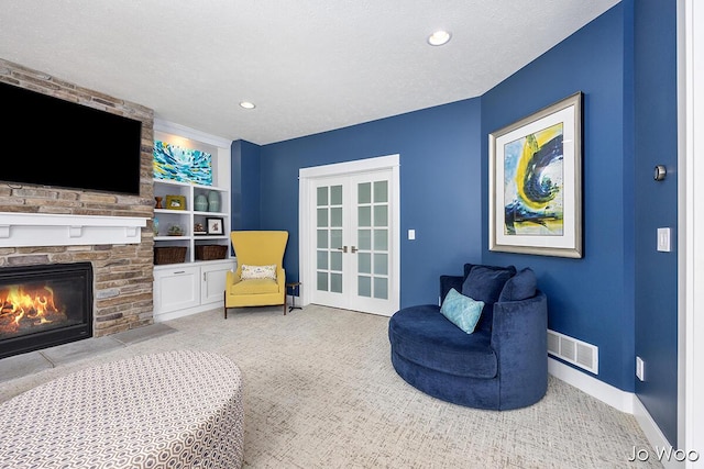 5362 Settlers Grove Rd NE, Belmont, MI 49306 - sitting room with carpet, a stone fireplace, french doors, recessed lighting, and built in features