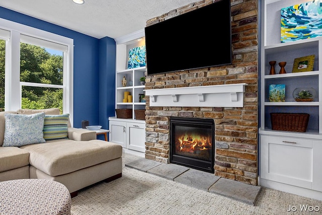 5362 Settlers Grove Rd NE, Belmont, MI 49306 - living room featuring a textured ceiling, a fireplace, and built in shelves