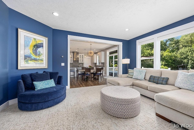 5362 Settlers Grove Rd NE, Belmont, MI 49306 - living room featuring wood finished floors, a textured ceiling, recessed lighting, and a chandelier