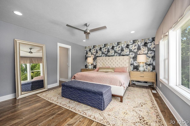 5362 Settlers Grove Rd NE, Belmont, MI 49306 - bedroom featuring an accent wall, multiple windows, dark wood-type flooring, wallpapered walls, and a ceiling fan
