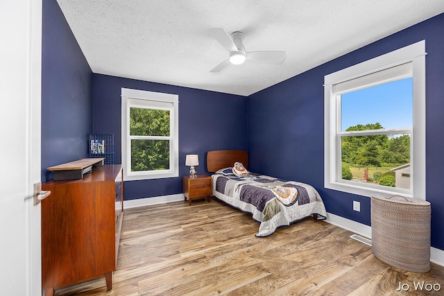 5362 Settlers Grove Rd NE, Belmont, MI 49306 - bedroom featuring wood finished floors, ceiling fan, and a textured ceiling