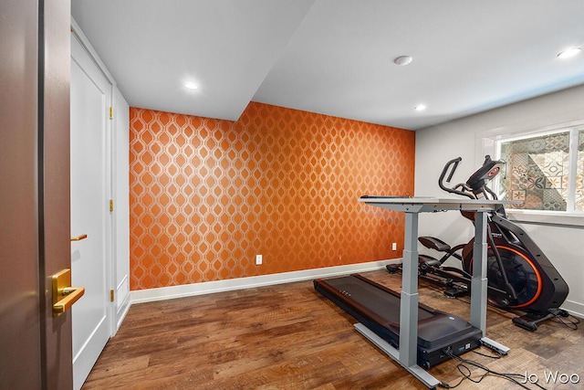 5362 Settlers Grove Rd NE, Belmont, MI 49306 - exercise area with wallpapered walls, an accent wall, wood finished floors, and recessed lighting