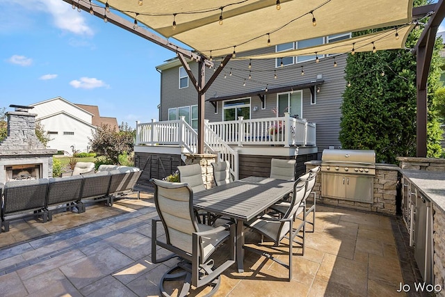 5362 Settlers Grove Rd NE, Belmont, MI 49306 - view of patio / terrace with outdoor dining space, exterior kitchen, a wooden deck, and an outdoor living space with a fireplace
