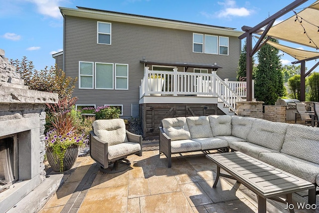 5362 Settlers Grove Rd NE, Belmont, MI 49306 - back of property with an outdoor living space with a fireplace, stairway, a patio area, a wooden deck, and exterior kitchen