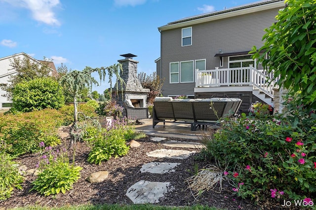 5362 Settlers Grove Rd NE, Belmont, MI 49306 - back of house featuring an outdoor living space with a fireplace, a patio area, and a wooden deck