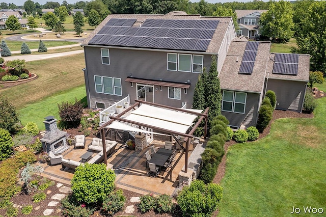 5362 Settlers Grove Rd NE, Belmont, MI 49306 - back of property with a patio, a yard, an outdoor living space, and roof mounted solar panels