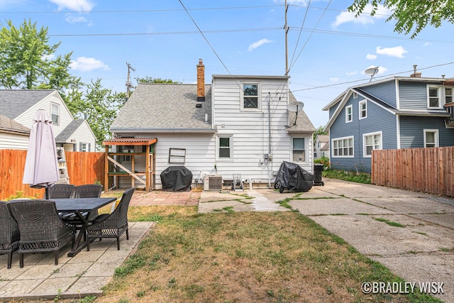 302 W 22nd St, Holland, MI 49423 - rear view of property with a patio, roof with shingles, and a chimney