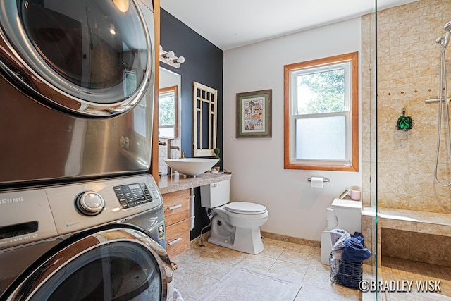 302 W 22nd St, Holland, MI 49423 - washroom featuring stacked washing machine and dryer and tile patterned flooring