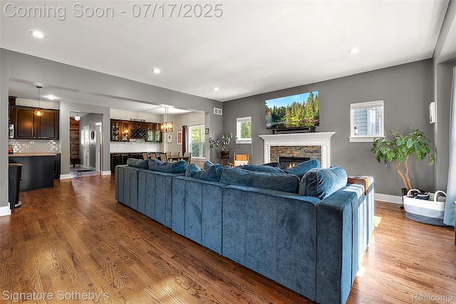 1120 Wyandotte Ave, Royal Oak, MI 48067 - living room featuring a stone fireplace, wood finished floors, healthy amount of natural light, and recessed lighting