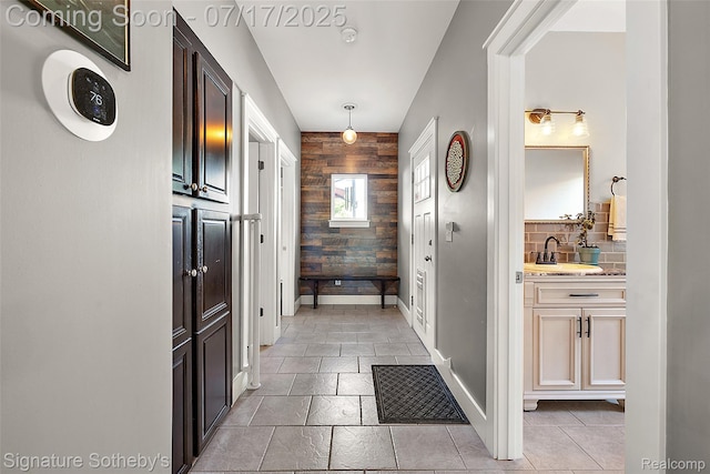 1120 Wyandotte Ave, Royal Oak, MI 48067 - hall featuring an accent wall and wooden walls