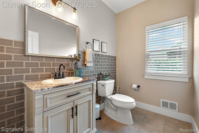 1120 Wyandotte Ave, Royal Oak, MI 48067 - bathroom with tile patterned flooring, vanity, and tile walls