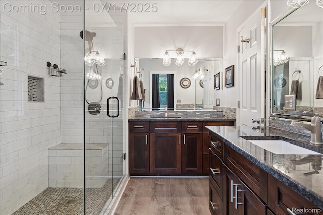 1847 Brandy Ln, Brighton, MI 48114 - full bath featuring a stall shower, two vanities, wood finished floors, and a chandelier