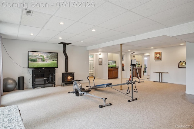 1847 Brandy Ln, Brighton, MI 48114 - exercise area featuring a wood stove, carpet, a drop ceiling, and recessed lighting