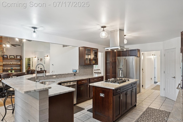 1847 Brandy Ln, Brighton, MI 48114 - kitchen featuring island range hood, tasteful backsplash, light tile patterned flooring, appliances with stainless steel finishes, and dark brown cabinets