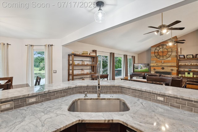 1847 Brandy Ln, Brighton, MI 48114 - kitchen with open floor plan, healthy amount of natural light, a ceiling fan, light stone countertops, and vaulted ceiling