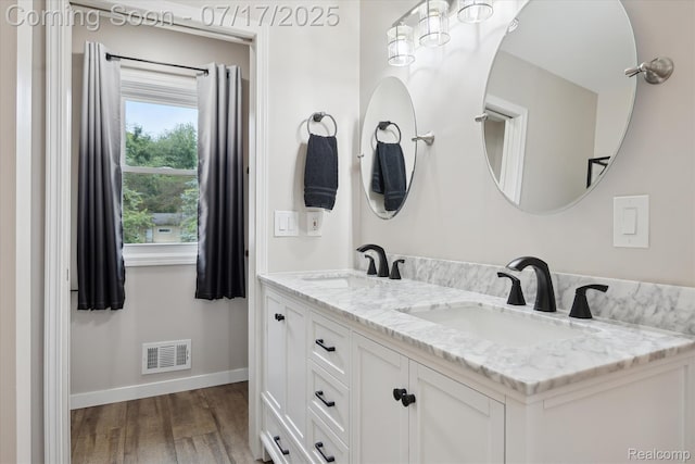 1847 Brandy Ln, Brighton, MI 48114 - full bathroom with double vanity and wood finished floors