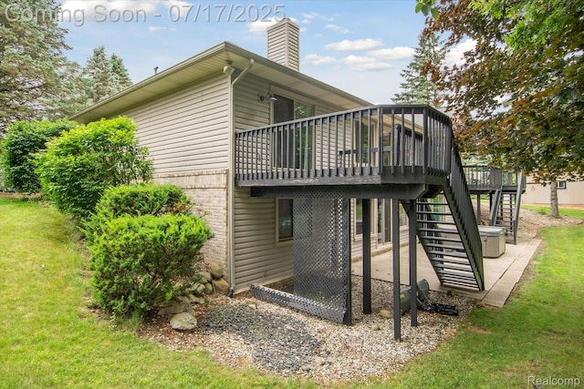 1847 Brandy Ln, Brighton, MI 48114 - back of house with a patio area, a wooden deck, a lawn, and a chimney