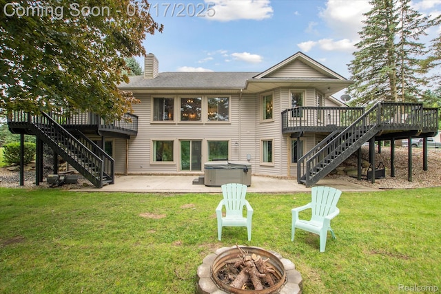 1847 Brandy Ln, Brighton, MI 48114 - rear view of house with stairway, a hot tub, an outdoor fire pit, and a wooden deck