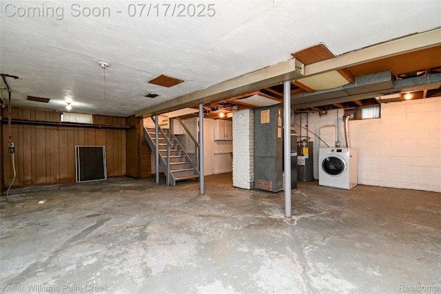 43 Charlevoix St, Clawson, MI 48017 - unfinished basement with washer / clothes dryer, electric water heater, heating unit, stairway, and wooden walls