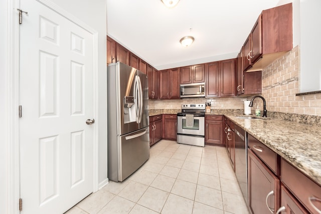 241 W Oakbrook Dr, Ann Arbor, MI 48103 - kitchen with stainless steel appliances, decorative backsplash, light tile patterned flooring, and light stone counters