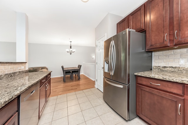 241 W Oakbrook Dr, Ann Arbor, MI 48103 - kitchen with stainless steel appliances, tasteful backsplash, a chandelier, light stone countertops, and light tile patterned flooring