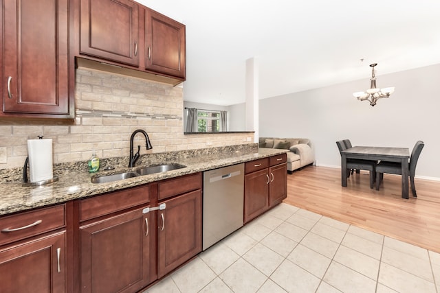 241 W Oakbrook Dr, Ann Arbor, MI 48103 - kitchen with dishwasher, backsplash, a chandelier, light tile patterned flooring, and light stone counters