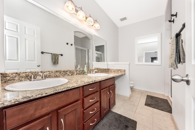 241 W Oakbrook Dr, Ann Arbor, MI 48103 - bathroom with a shower stall, double vanity, and tile patterned floors