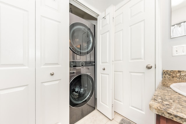 241 W Oakbrook Dr, Ann Arbor, MI 48103 - laundry room featuring stacked washer / drying machine and light tile patterned flooring