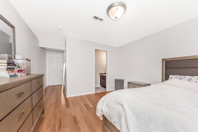 241 W Oakbrook Dr, Ann Arbor, MI 48103 - bedroom with light wood-style flooring and ensuite bath