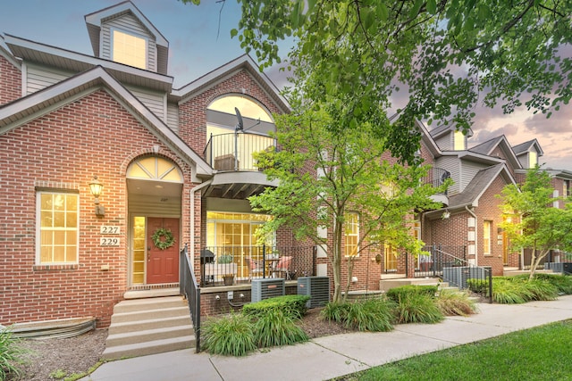 225 W Oakbrook Dr, Ann Arbor, MI 48103 - view of front of house with a balcony, brick siding, and covered porch