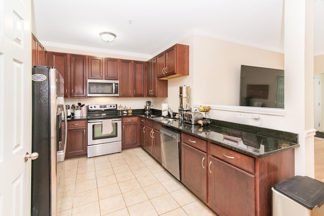 225 W Oakbrook Dr, Ann Arbor, MI 48103 - kitchen featuring appliances with stainless steel finishes, light tile patterned floors, crown molding, and dark stone countertops