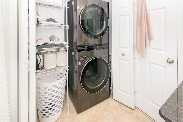 225 W Oakbrook Dr, Ann Arbor, MI 48103 - laundry room featuring stacked washing machine and dryer and light tile patterned floors