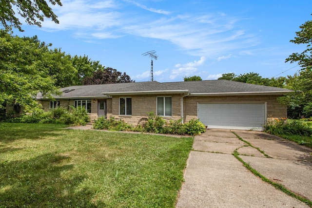 2597 E Glendora Rd, Buchanan, MI 49107 - ranch-style house with stone siding, concrete driveway, a front yard, a garage, and roof with shingles