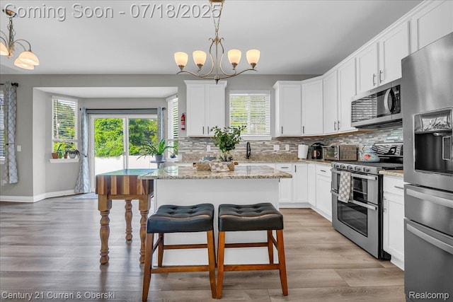 21150 Bryce Ct, Romulus, MI 48174 - kitchen featuring appliances with stainless steel finishes, healthy amount of natural light, and decorative backsplash