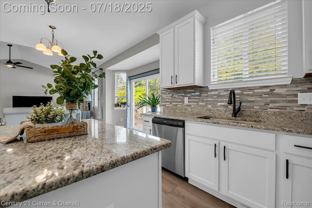 21150 Bryce Ct, Romulus, MI 48174 - kitchen featuring dishwasher, a ceiling fan, backsplash, wood finished floors, and white cabinetry