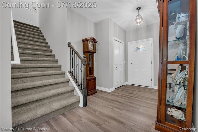 21150 Bryce Ct, Romulus, MI 48174 - entryway with wood finished floors, stairway, and a chandelier