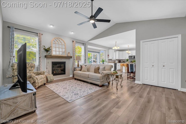 21150 Bryce Ct, Romulus, MI 48174 - living area with ceiling fan, lofted ceiling, light wood finished floors, healthy amount of natural light, and recessed lighting