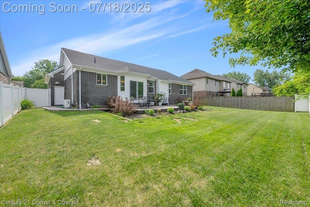 21150 Bryce Ct, Romulus, MI 48174 - back of property featuring brick siding, a patio, and a fenced backyard