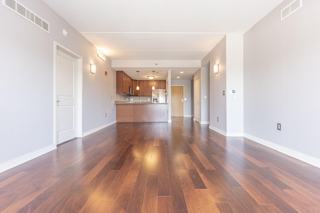 111 N Ashley St Unit 412, Ann Arbor, MI 48104 - unfurnished living room with dark wood-style floors and baseboards