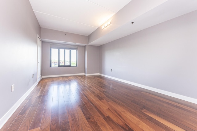 111 N Ashley St Unit 412, Ann Arbor, MI 48104 - spare room featuring dark wood-type flooring and baseboards